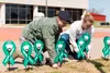 Tech. Sgt. Rebecca Willemstein, 138th Security Forces Squadron, and Breanna Ault, Student Flight, place ribbons near high traffic areas to bring sexual awareness to the number of cases report