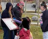 WHS junior Audrey Cox and WHS girls basketball coach Jeannie Hebert-Truax helped give out Halloween treats as children walked along the Story Walk as part of the Wasilla Public Library Hallow