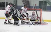 Houston goalie Aaron Allred leaves no daylight for Hutchison during a first-period flurry in front of the goal in Saturday’s ASAA Greatland First National Cup championship game at the Menard 