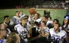 Longtime Palmer football coach Rod Christiansen lifts the Mayor's Cup trophy after a win over Wasilla during his final season as head coach. Bruce Eggleston/matsusports.net