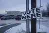 A sign directs voters to the polling site set up on Tuesday in the YMCA in Midtown Anchorage.  Yereth Rosen/Alaska Beacon
