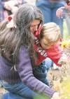 Felicia Brusatto and her son Garrett place a marker in memory of
her grandmother, Erna Breen, at the base of a memory tree Saturday
at the Alaska State Fairground's perennial garden. Brusatto