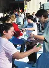 Cans are passed by students at Wasilla Lake Christian Church
last Friday. More than 1,300 food items were donated by the
students. Photo by CASEY RESSLER/Frontiersman.