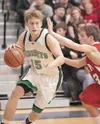 Colony forward Grant Niver charges past Kenai Kardinal Nate
Saltzgiver during Saturday's Northern Lights Conference
championship game at Palmer High School. (ROBERT
DeBERRY/Frontiersman)