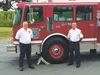 BP Alaska Fire Chief for Prudhoe Bay Doug Frey and West Lakes Fire and Rescue District Chief Bill Gamble pose for a photo in front of ‘Big Ben’ during a ceremony at Station 71 Thursday.