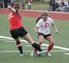 Wasilla's Teyonnah Williams tries to keep the ball away from Kenai's Caitlin Steinbeck during Kenai's 2-0 win over the Warriors in the first round of the ASAA/First National Bank State Soccer