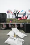 (ROBERT DeBERRY/Frontiersman) Symbolic like the 1773 Boston Tea
Party against taxation, Frank Bettine throws a bag of tea off a
flatbed trailer at a tax day tea party which was organized by a
