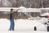 Wasilla resident Darren Rudolph uses a broom to brush snow off
his plane at the Palmer Airport Monday morning. (ROBERT
DeBERRY/Frontiersman) Robert DeBerry