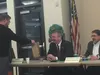 Alaska House Legislator Dan Saddler accepts his bag of gifts from a speaker at Wednesday night’s town hall at the Palmer Senior Center. MATT HICKMAN/Frontiersman
