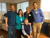 The team from Mat-Su Regional Advanced Wound Care and Hyperbaric Therapy Center stands behind Janette Melton in the room where she received her treatment. From left to right: Dennis Ray Barre