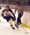Colony's Chris Crosta skates the puck down the ice for the
Knights in their 15-3 victory over the Nikiski Bulldogs on Friday.
Crosta scored a hat trick in the contest. Photo by JEREMIAH BARTZ