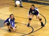 Palmer's Aurora Davidson picks up the dig as teammate Gina Bodnar watches during a 3-2 loss to rival Wasilla Tuesday, Sept. 26, 2017, at Palmer High School. Jeremiah Bartz/Frontiersman