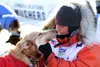 Big Lake's Kristin Bacon shows some love to her lead dog, Felon, in the bright sunlight after finishing her first Iditarod on Saturday afternoon. CAITLIN SKVORC/Frontiersman.com