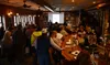 Members of Alaska CHARR, the state alcohol trade association, listen as Democratic governor candidate Les Gara speaks during a forum on Wednesday, Oct. 5, 2022, at Louie's Douglas Inn in June
