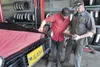 Ryan Johnston and Rob Collins take advantage of a photo-op and
pretend to check the diagnostics of the Midas bed racer while it
sits on the rack Thursday afternoon. Colony Days begins Friday 