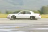 ROBERT DeBERRY/Frontiersman Wasilla police office Ben Dudley
speeds along a closed course in a training vehicle equippd with a
Skidcar Systems device that helps simulate adverse driving
condi