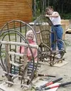 Friends and neighbors at Nancy Lake, Jeanine St. John (in
back)and Beth Gamel work on their first-ever chairs during a recent
rustic-furniture-making class led by Debbie Filter of Trapper Cre