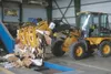 A loader dumps cardboard onto a conveyor feeding a new baler at the Valley Community for Recycling Solutions facility that will allow that group to expand the amount of material it can recycl