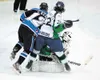Alaska defenseman Joe Schmitz protects goalie Bodhi Engum and delivers a check to Wenatchee’s Chris Kerr during the second period of Game 4 of the teams’ best-of-5 playoff series Friday at th