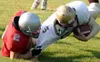 Wasilla's Zach Bennett tackles Dimond quarterback Danny Moss
during the first week of the season. Bennett and the Warriors will
return to Wasilla High School's Veterans Memorial Field for the