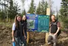 Great Land Trust staff Ellen Kazary (front left), Libby Kugel (rear left) and Matt McMillan stand in front of the park information sign at the newly opened Settlers Bay Coastal Park. Jacob Ma