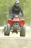 (ROBERT DeBERRY/Frontiersman) A 21-year-old ATV rider who chose
not to be identified catches a little air as he makes his way along
the ATV trail that runs along Knik Goose Bay Road Thursday
