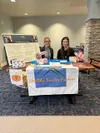 Royann Royer, left, director of Happy Smiles Forever, staffs an information booth at the Maple Springs long-term care facility. Photo courtesy of Happy Smiles Forever