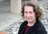 Gloria Hensel smiles for a photo on a bench outside Mat-Su College, where she has taught for 42 years. According to the college's director, Talis Colberg, Hensel is the school's longest emplo