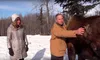 Research biologist Bill Collins shows Liz Jackson of Hatcher Pass Bed and Breakfast one of the moose from the small herd he keeps at the Palmer Experiment Farm. The mammals have fistulas on t