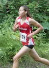 Wasilla freshman Alex Mathis rounds a corner on the Colony Trails during the Colony Invitational Saturday at Colony High School. Mathis finished second in the girls’ race, and recorded her th