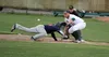 Mat-Su infielder Spencer Henson takes the throw to first as Chugiak-Eagle River's Justin Gomez slides back into the bag during a 10-4 win over the Chinooks Tuesday at Hermon Brothers Field in