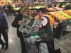 Debbie Robinson, left, a Palmer resident since 1973, looks over bargains at the grand opening of the new Fred Meyer store on Friday.  MATT HICKMAN/Frontiersman