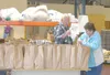 HANNAH GUILLAUME/Frontiersman Daryl, left, and Jeanne McRoberts,
food managers at the Valley Food Pantry, prepare food for families
in need to take home. The owner of the warehouse that house