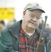 ROBERT DeBERRY/Frontiersman Wasilla resident Dal “Smitty” Smith
looks at a Remington Rolling Block replica Saturday at the Palmer
Lions Gun Show at the Alaska State Fairgrounds.