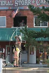 Central Mat-Su Fire Department firefighters pass firearms from the second story of the Point MacKenzie General Store and Cafe Thursday after and early morning fire damaged the building. No on
