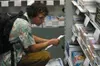 James Kase, a sophomore at Mat-Su College, looks through
textbooks at the Mat-Su College bookstore as he prepares for the
first week of classes. Photo by JOEL DAVIDSON/Frontiersman.