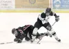 ROBERT DeBERRY/Frontiersman Colony junior Daryl Belanger takes
the puck as he checks Kenai’s Morgan Cunningham to the ice during
Saturday’s game at the Curtis C. Menard II Memorial Ice Arena 