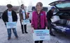 Joelle Hall, president of the Alaska AFL-CIO, carries a box of signed petitions for an increased minimum wage to be delivered to the Alaska Division of Elections on Tuesday. Hall is a leader 