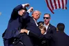 Republican presidential candidate former President Donald Trump is surround by U.S. Secret Service agents at a campaign rally, Saturday, July 13, 2024, in Butler, Pa. AP Photo/Evan Vucci