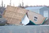 A flipped building sits along the palmer-Wasilla Highway
Thursday morning after two days of high wind with gusts exceeding
75 mph left a trail of broken signs, overturned semi trucks and
tras