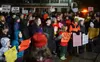 Participants in a pro-education rally hold signs in front of the Alaska State Capitol on Monday night, Jan. 23, 2023. James Brooks/Alaska Beacon