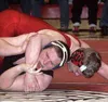 Wasilla's Jeramee Meisler, top, battles to control Dennis Bryant
of Kodiak during the third-place match in the 215-pound division.
Photo by TIM BRODT/Frontiersman.