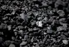 ADVANCE FOR MONDAY, JULY 28, 2014, AT 12:01 A.M. AND THEREAFTER - In this May 22, 2014, photo, sunlight reflects off of a chunk of coal at Dominion Terminal Associates' coal terminal in Newpo