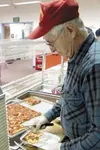 Retired Marine Corps officer Hal Campbell fills lunchboxes with
homemade pizza from the kitchen of the Wasilla Area Seniors Inc.
for delivery to area seniors. Photo by Mary Spears/For the
Fro