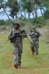 U.S. Air Force Tech. Sgt. Rowdy Spears, 736th Security Forces Squadron noncommissioned officer in charge of standards and evaluations, approaches a training scenario during Pacific Defender 2