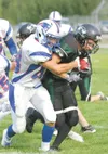 North Pole’s Josh Hollett tries to bring down Colony junior
running back Skye Rench during the Knights’ 17-7 win over the
Patriots at Colony High School on Saturday. North Pole entered the
ga