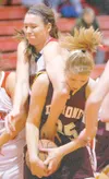 ROBERT DeBERRY/Frontiersman Wasilla forward Kelsey Cottle
reaches over Dimond’s Katie Anderson during Thursday’s game at
Wasilla High School.