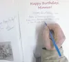 Colony ‘kid’ Earl Wineck, 84, signs a birthday card in August 2011 for Minnie Olson, the oldest Colonist from the group that arrived in Palmer in May 1935. The last of the original 404 adults