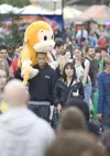 Nolie Libao carries a giant stuffed animal on his shoulders as
he makes his way through the crowd at the Alaska State Fair in
Palmer. Libao won the prize for his girlfriend at rollerball. For