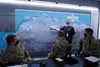 JOINT BASE ELMENDORF-RICHARDSON, Alaska -- North Slope Borough Search and Rescue coordinator Lewis Brower briefs member of an Alaskan Command survey team at the SAR agency’s Utqiagvik facilit